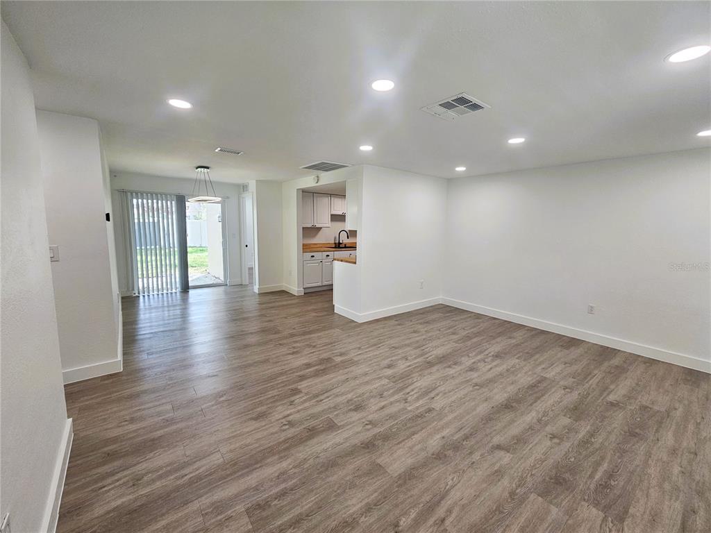 12218 Shadow Ridge Boulevard Hudson, FL 34669 - Photo 9 of 34 an empty room with wooden floor and window