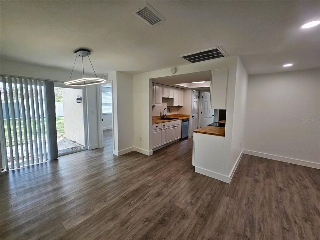 12218 Shadow Ridge Boulevard Hudson, FL 34669 - Photo 10 of 34 a view of a kitchen with a sink stove cabinets and empty room