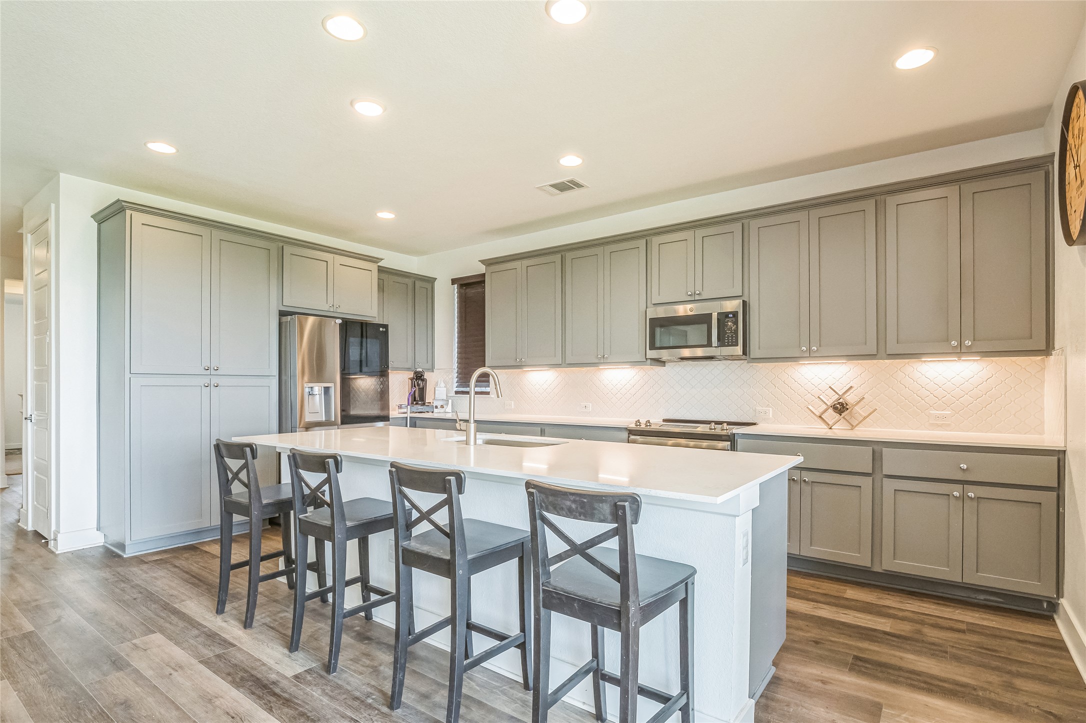 3706 Mesquite Vly Road Georgetown, TX 78628 - Photo 7 of 30 Kitchen with appliances with stainless steel finishes, a sink, a center island with sink, dark wood finished floors, and a breakfast bar