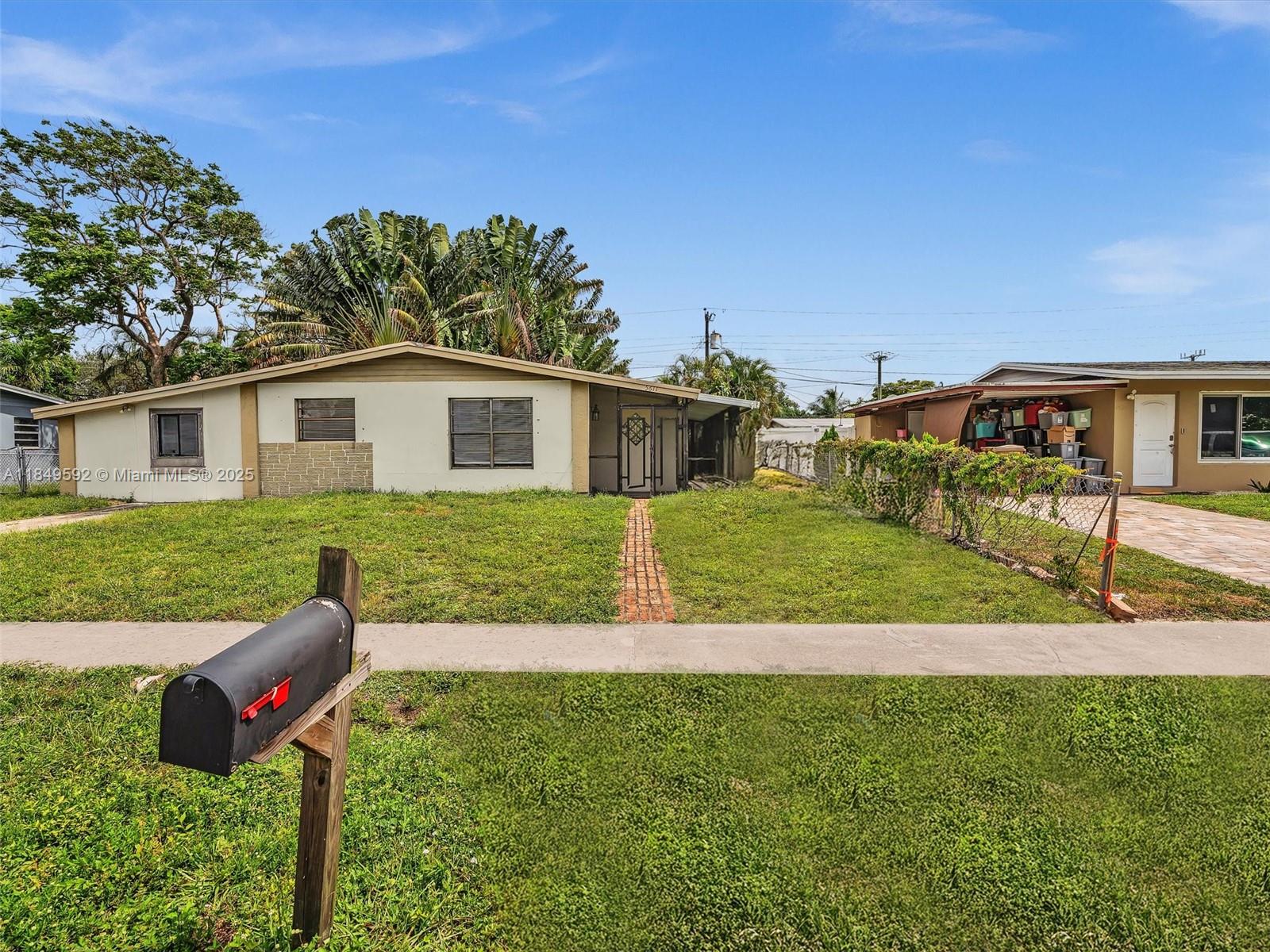 5611 Southwest 37th Street, Unit 1 Davie, FL 33314 - Photo 1 of 46 a front view of a house with garden