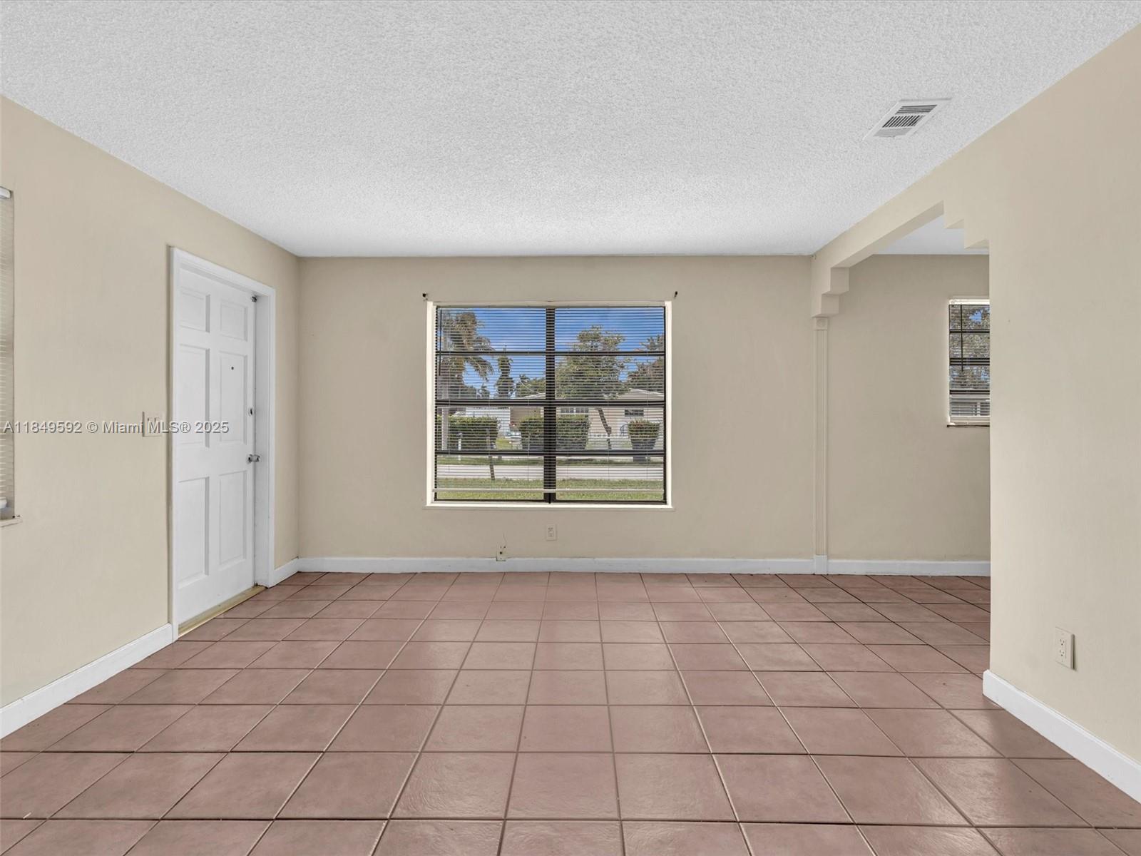 5611 Southwest 37th Street, Unit 1 Davie, FL 33314 - Photo 11 of 46 a view of an empty room with a window