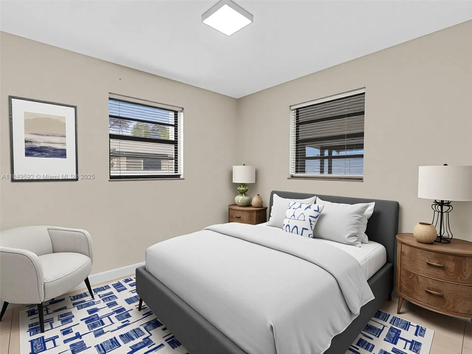 5611 Southwest 37th Street, Unit 1 Davie, FL 33314 - Photo 13 of 46 a bedroom with bed and a lamp on dresser