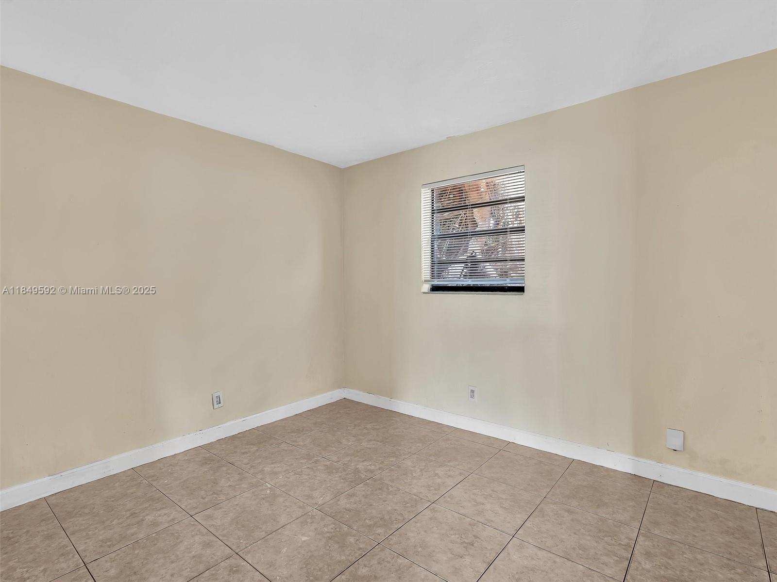 5611 Southwest 37th Street, Unit 1 Davie, FL 33314 - Photo 17 of 46 an empty room with a empty space and window