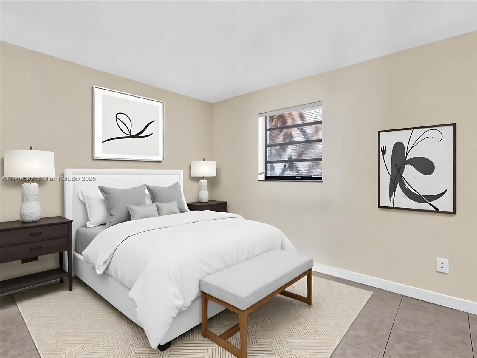 5611 Southwest 37th Street, Unit 1 Davie, FL 33314 - Photo 18 of 46 a bedroom with a bed and a lamp on dresser