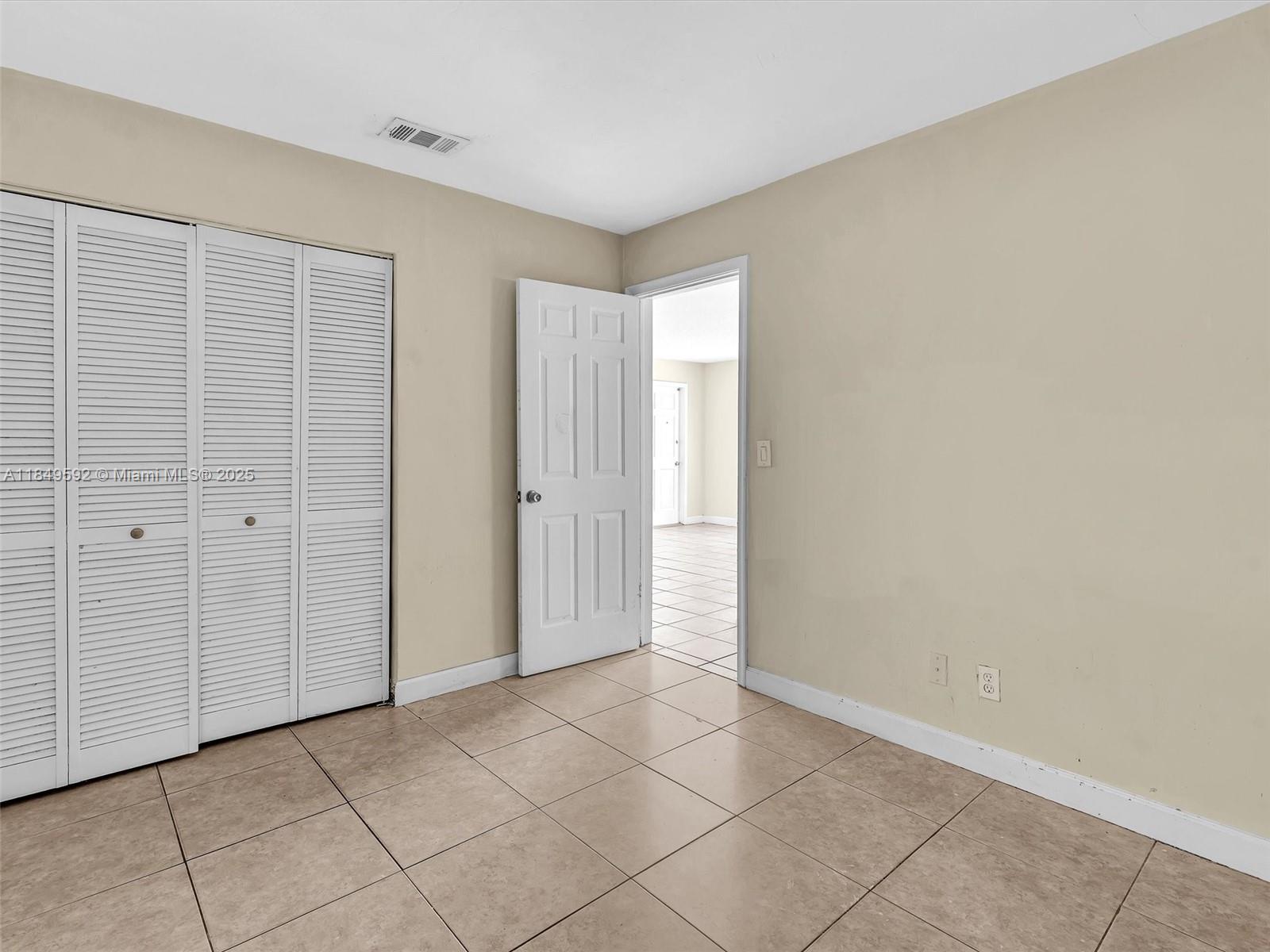 5611 Southwest 37th Street, Unit 1 Davie, FL 33314 - Photo 19 of 46 a view of an empty room with window