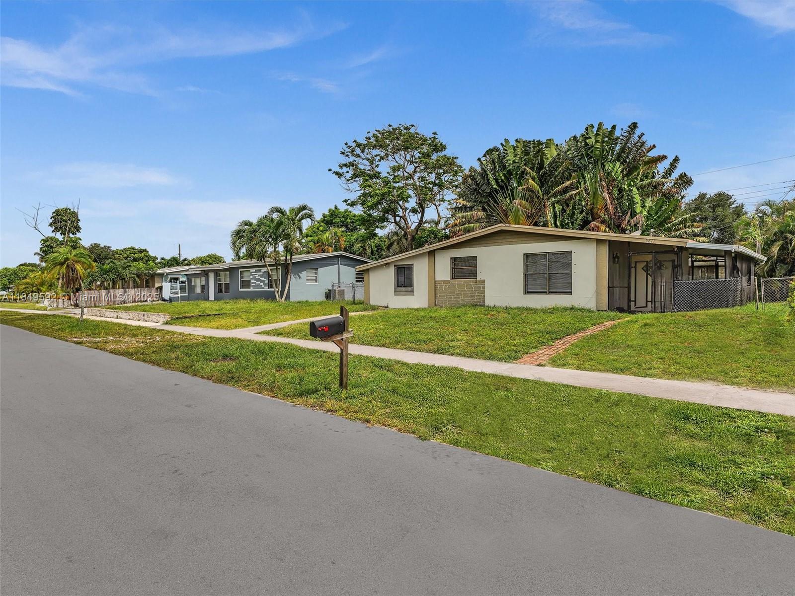 5611 Southwest 37th Street, Unit 1 Davie, FL 33314 - Photo 2 of 46 a view of a house with a yard and potted plants
