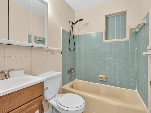 a kitchen with cabinets stainless steel appliances and a window