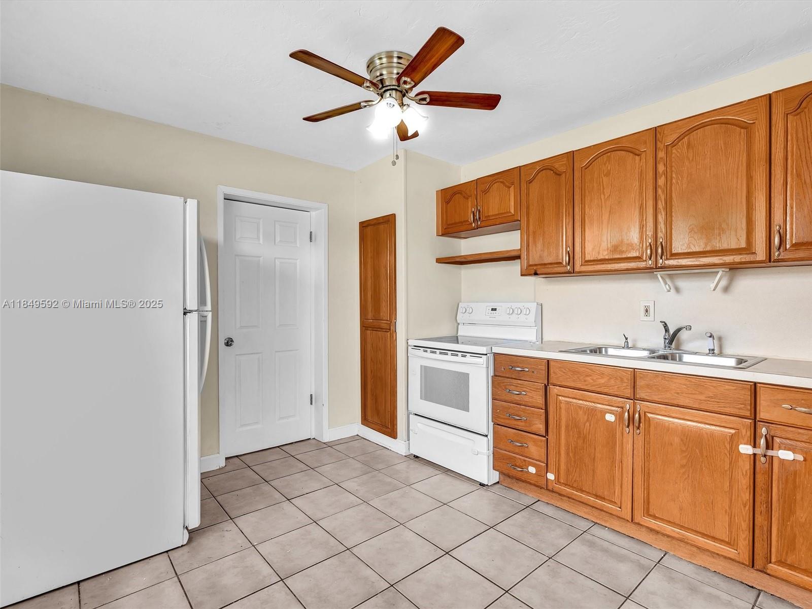 5611 Southwest 37th Street, Unit 1 Davie, FL 33314 - Photo 22 of 46 a kitchen with cabinets stainless steel appliances and a window