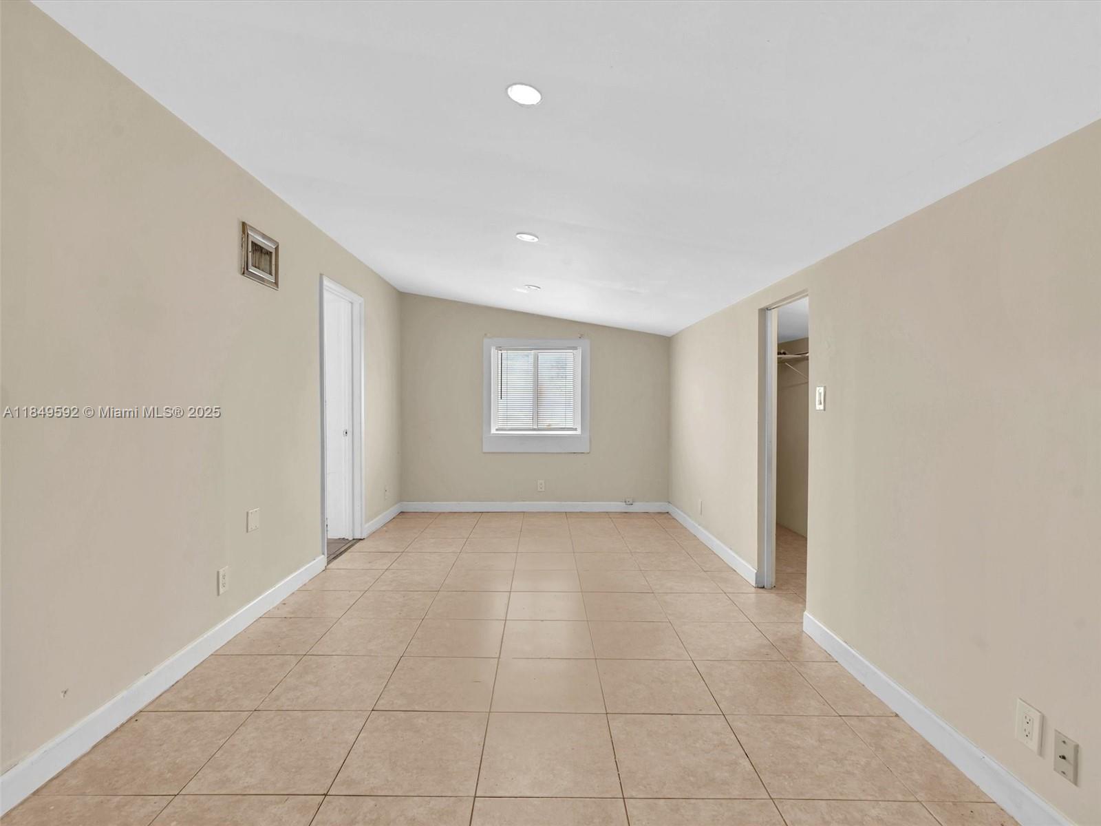 5611 Southwest 37th Street, Unit 1 Davie, FL 33314 - Photo 30 of 46 a view of an empty room with a window