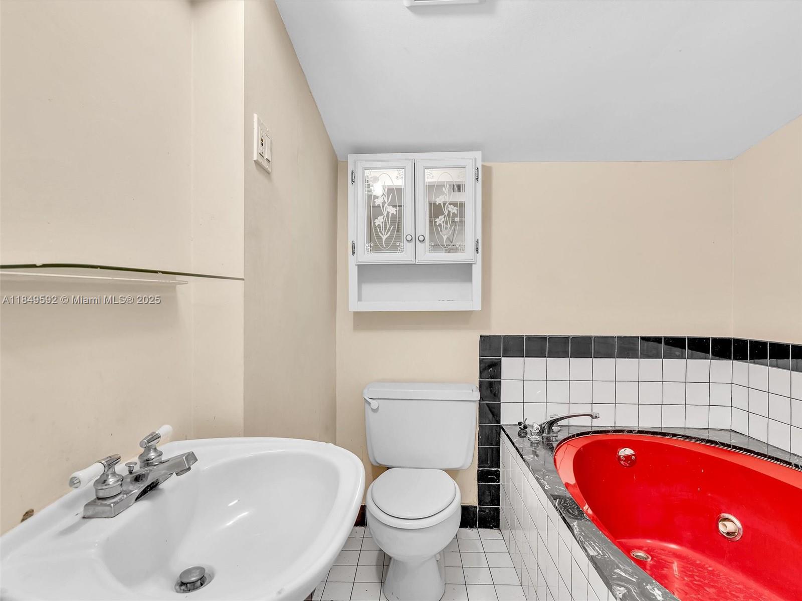 5611 Southwest 37th Street, Unit 1 Davie, FL 33314 - Photo 31 of 46 a bathroom with a sink toilet and shower