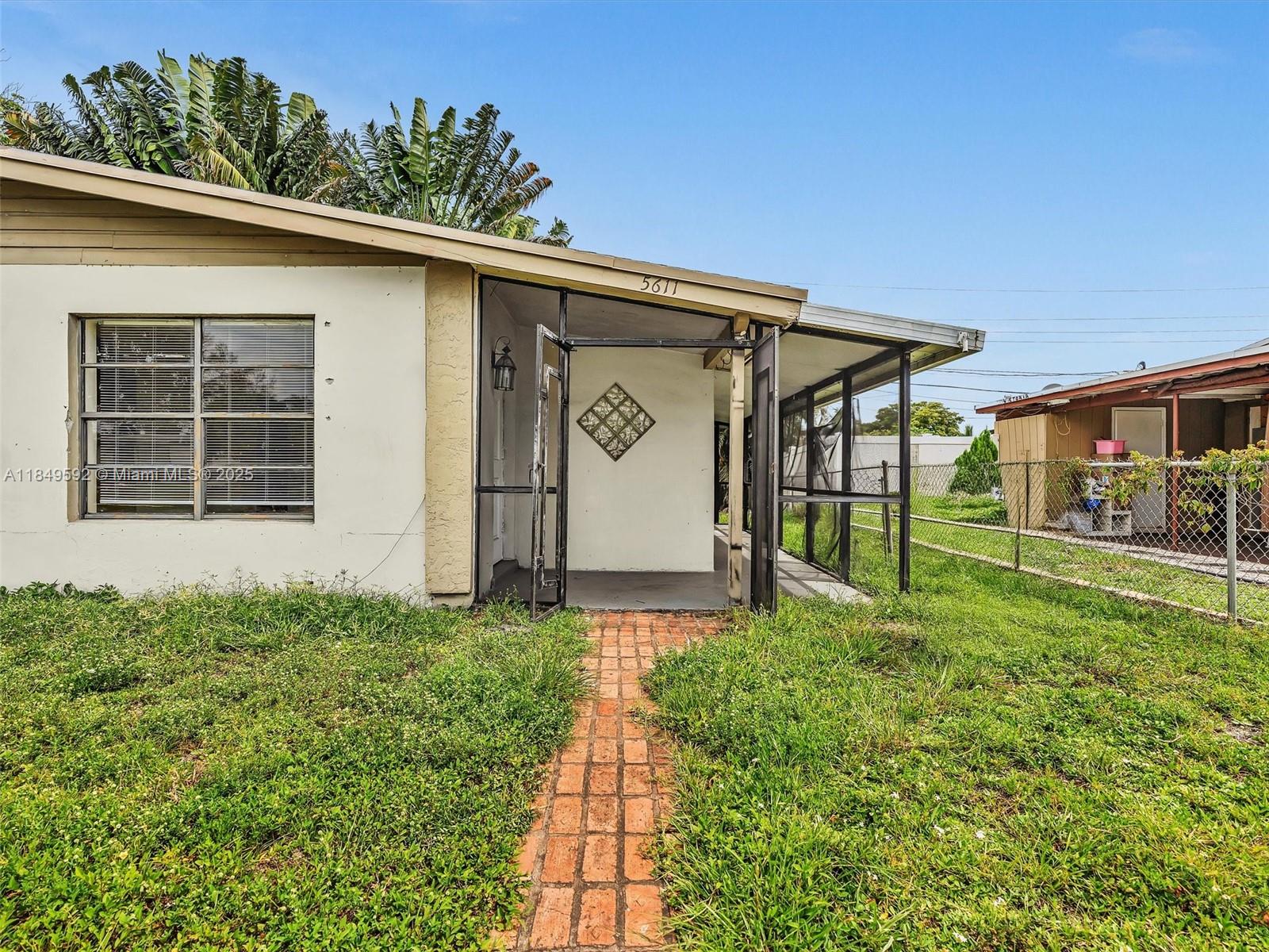 5611 Southwest 37th Street, Unit 1 Davie, FL 33314 - Photo 35 of 46 a front view of a house with garden