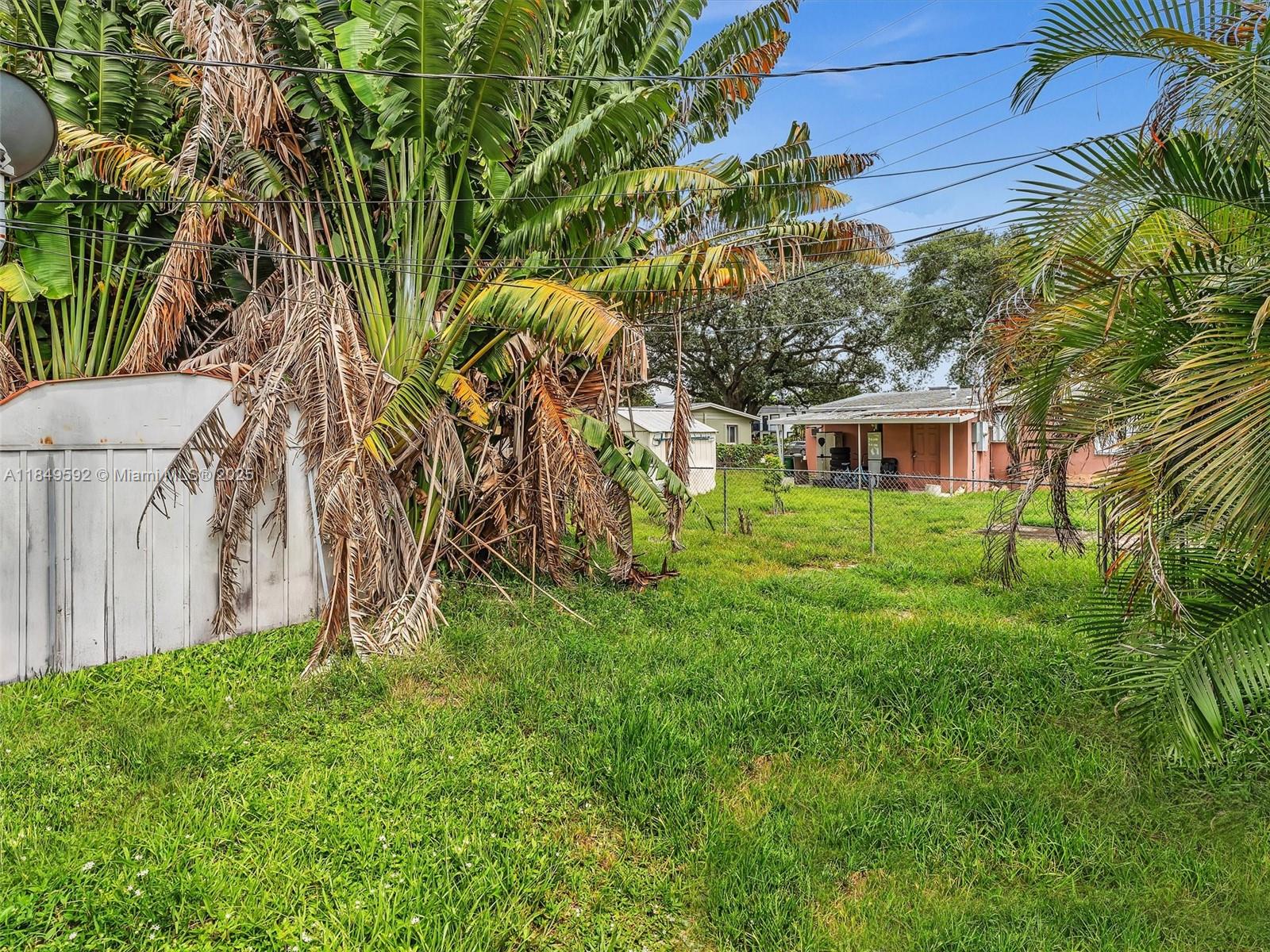 5611 Southwest 37th Street, Unit 1 Davie, FL 33314 - Photo 36 of 46 a view of backyard with a garden and trees