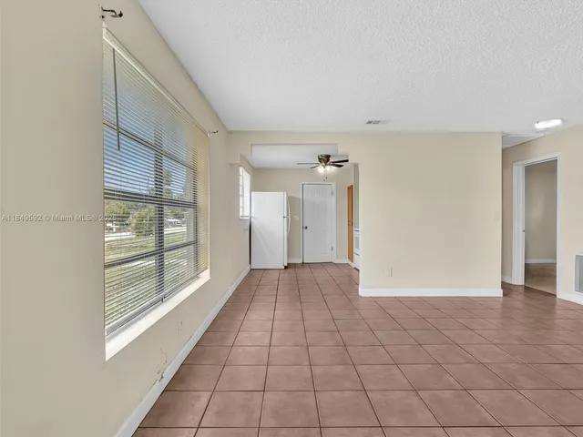 a view of a room with an empty space and a window