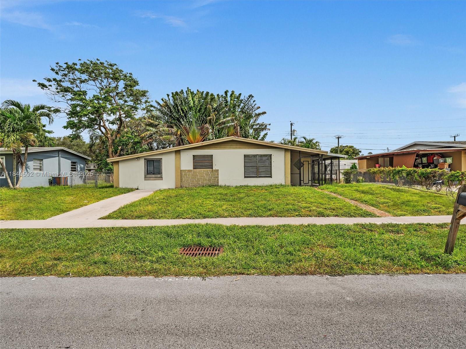 5611 Southwest 37th Street, Unit 1 Davie, FL 33314 - Photo 42 of 46 a view of a house with a yard