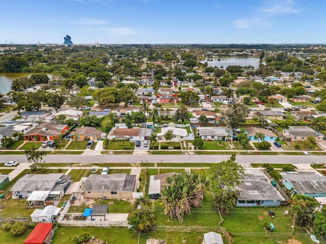 an aerial view of residential houses with outdoor space and street view