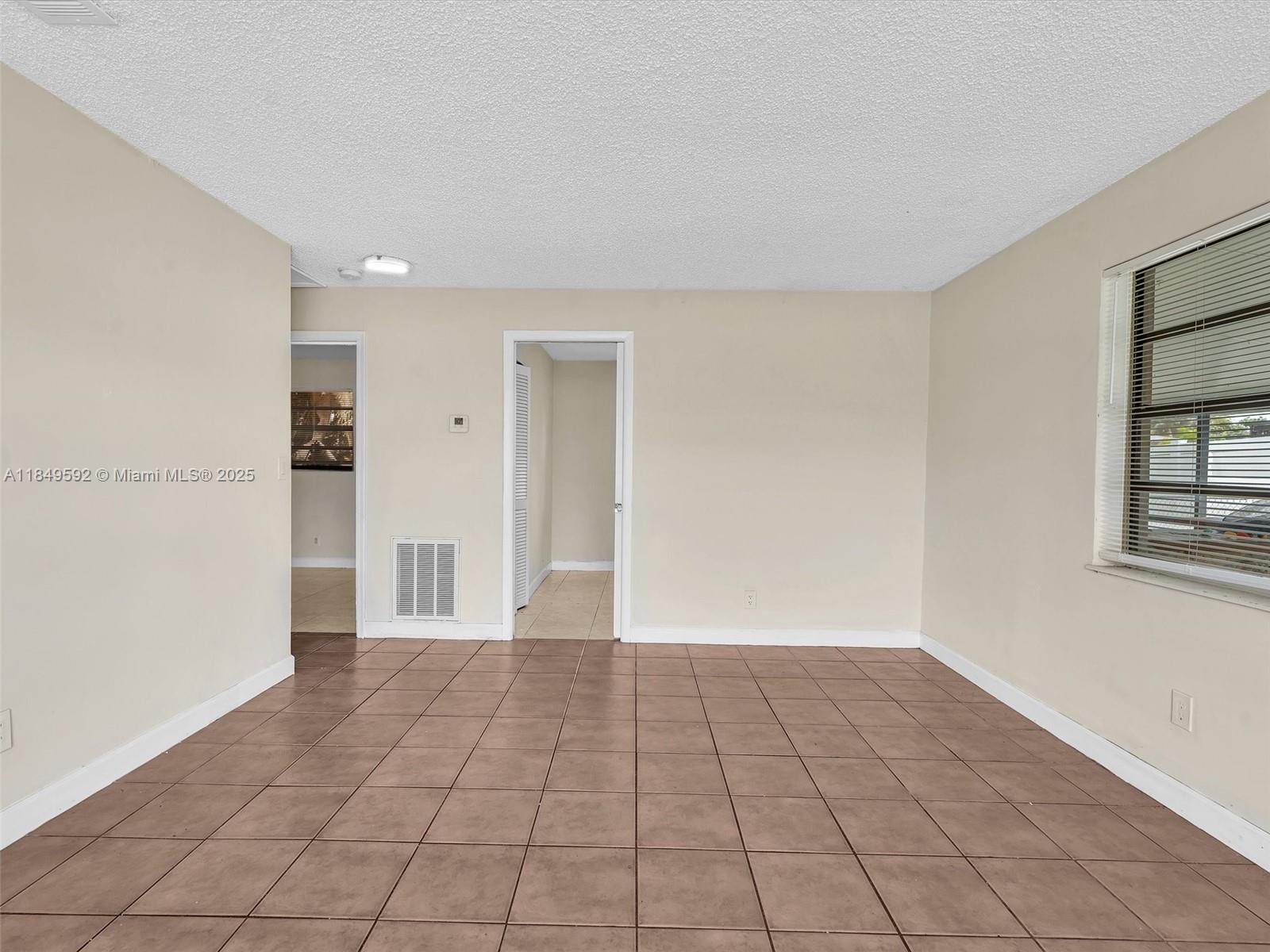 5611 Southwest 37th Street, Unit 1 Davie, FL 33314 - Photo 6 of 46 a view of a livingroom with an empty space and a window