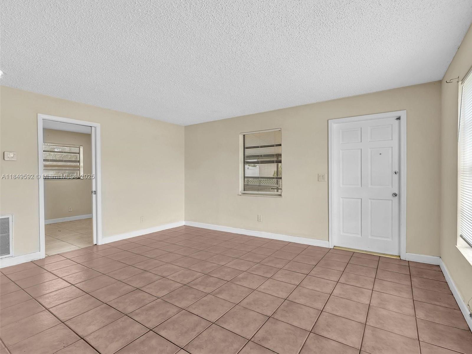 5611 Southwest 37th Street, Unit 1 Davie, FL 33314 - Photo 7 of 46 a view of an empty room and window