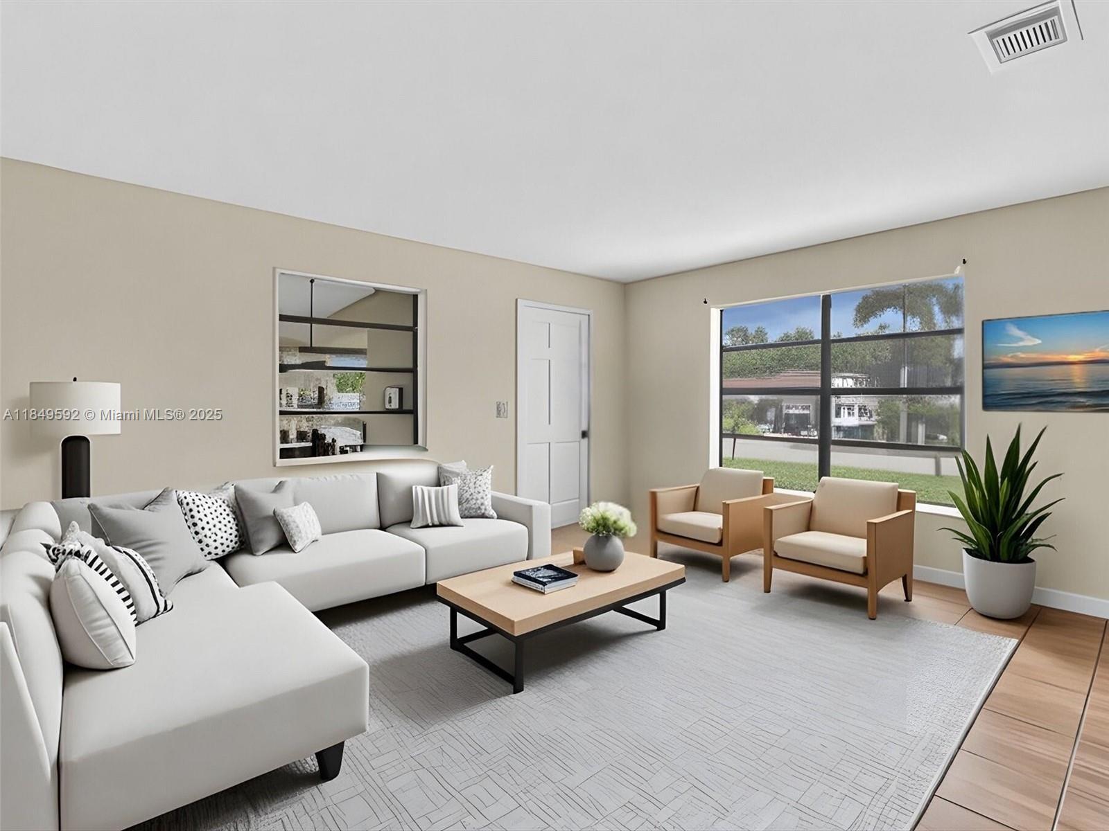 5611 Southwest 37th Street, Unit 1 Davie, FL 33314 - Photo 10 of 46 a living room with furniture and a large window