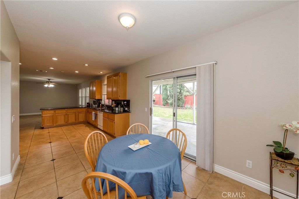 9220 Village Way Riverside, CA 92508 - Photo 11 of 73 a dining room with furniture a large window and wooden floor