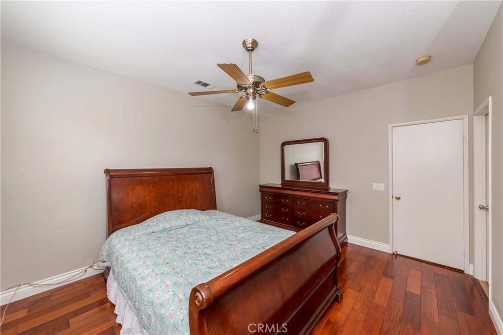 9220 Village Way Riverside, CA 92508 - Photo 13 of 73 a bedroom with a bed and a ceiling fan