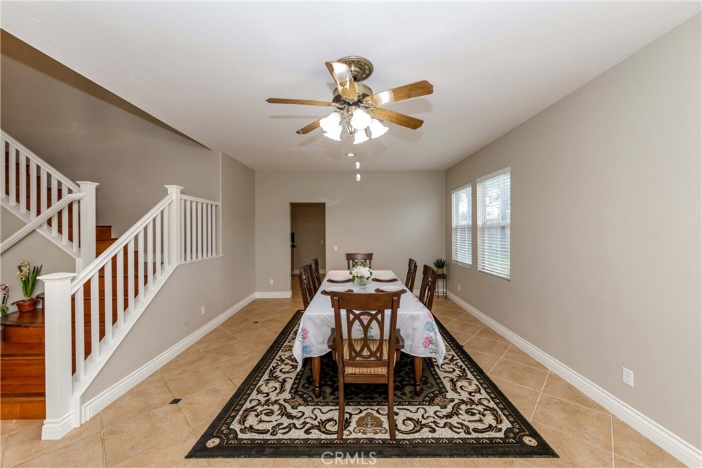 9220 Village Way Riverside, CA 92508 - Photo 22 of 73 a dining room with wooden floor and a chandelier