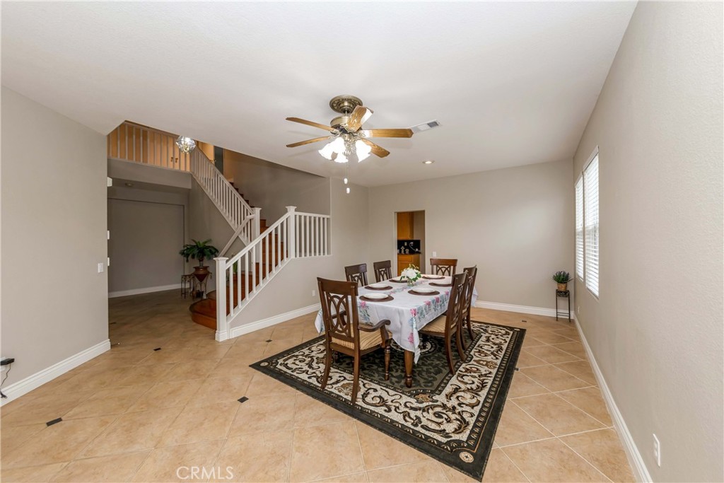 9220 Village Way Riverside, CA 92508 - Photo 23 of 73 a dining room with furniture a rug and a chandelier