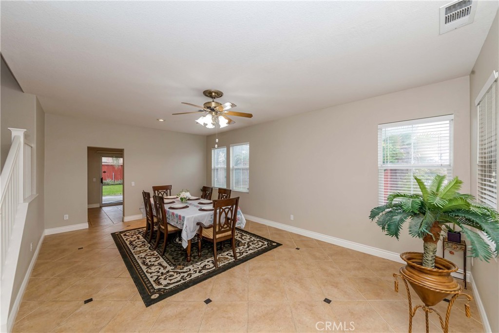 9220 Village Way Riverside, CA 92508 - Photo 24 of 73 a dining room with chandelier and wooden floor