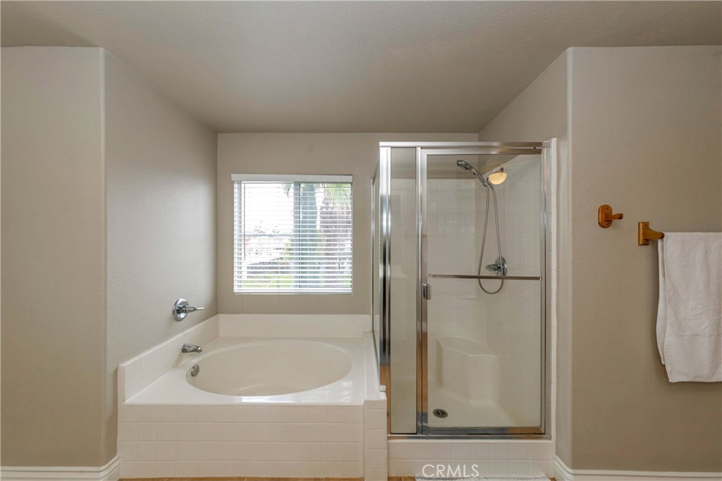 9220 Village Way Riverside, CA 92508 - Photo 33 of 73 a bathroom with a tub a window and a shower