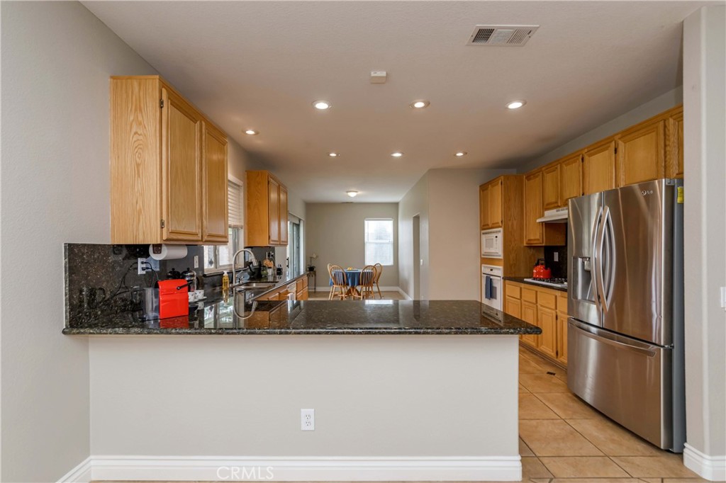 9220 Village Way Riverside, CA 92508 - Photo 4 of 73 a kitchen with stainless steel appliances granite countertop a refrigerator and a sink