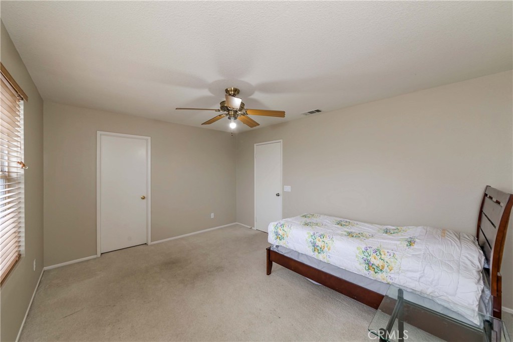 9220 Village Way Riverside, CA 92508 - Photo 46 of 73 a bedroom with a bed and a chandelier