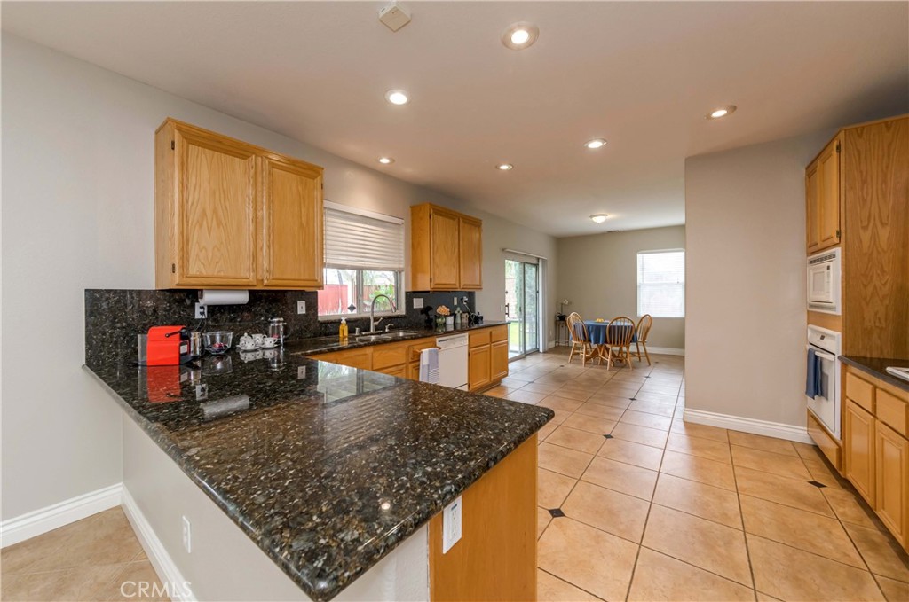 9220 Village Way Riverside, CA 92508 - Photo 5 of 73 a kitchen with stainless steel appliances granite countertop a sink counter space cabinets and a counter top space