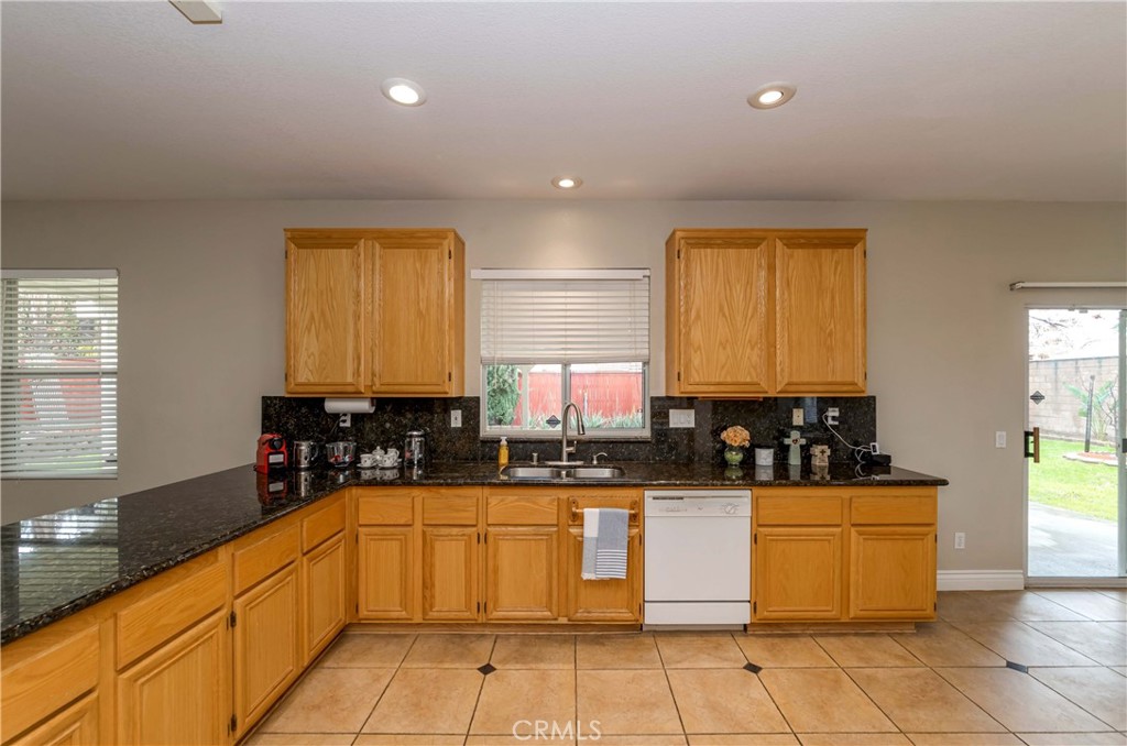 9220 Village Way Riverside, CA 92508 - Photo 6 of 73 a large kitchen with granite countertop a sink and cabinets