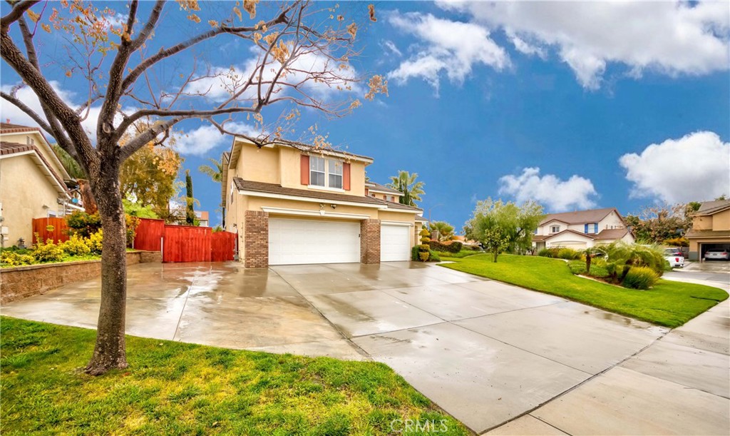 9220 Village Way Riverside, CA 92508 - Photo 68 of 73 a front view of a house with a yard and garage