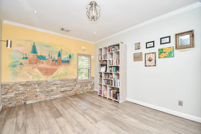 a view of empty room with wooden floor