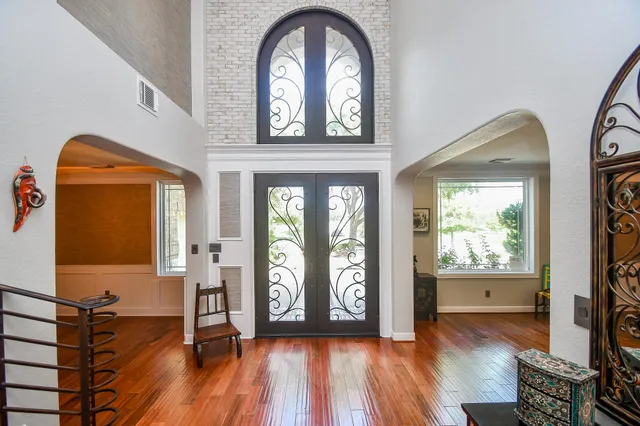 a view of entryway and hall with wooden floor