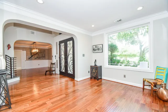 a view of a hallway with wooden floor and staircase