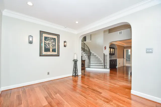 a kitchen with stainless steel appliances granite countertop a sink and a wooden floor