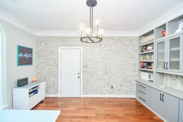 a view of a room with wooden floor and windows