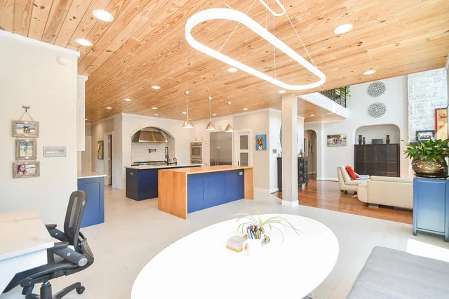 a living room with furniture and a large window with outer view