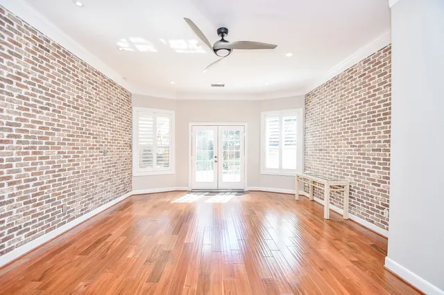 a view of a swimming pool with a bench and trees in the background