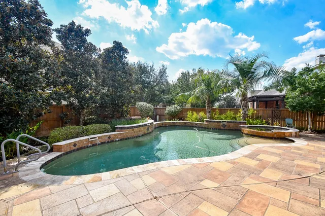 a view of a house with swimming pool and sitting area