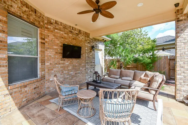 a view of a house with backyard and sitting area
