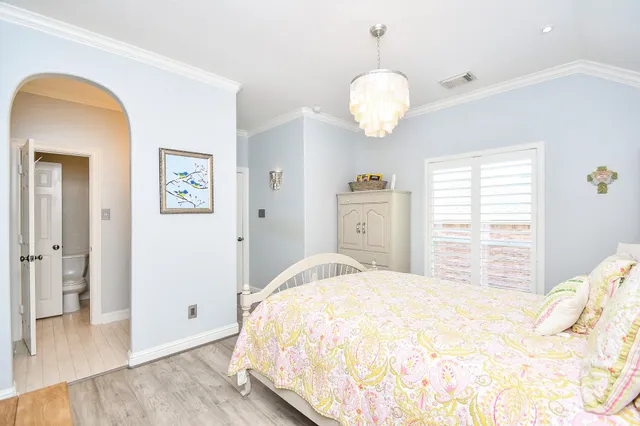 a bedroom with a bed and a chandelier