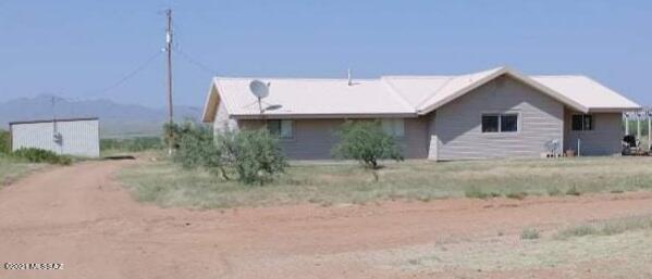 3440 East Howling Wolf Road Willcox, AZ 85643 - Photo 2 of 45 a view of a house with a yard and plants