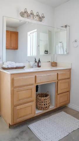 a spacious bathroom with a sink and a mirror