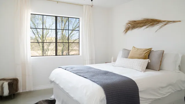 a bedroom with a bed and a window