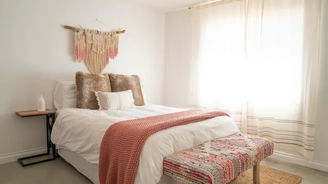 a bedroom with a bed and a night stand