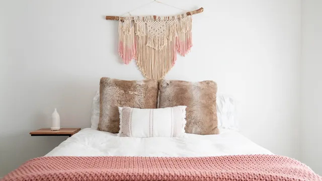 a bedroom with a bed and a night stand