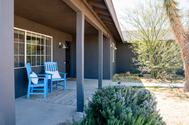 a backyard of a house with table and chairs
