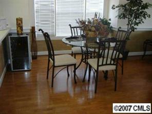 9070 Meadow Vista Road Charlotte, NC 28213 - Photo 2 of 8 a view of a dining room with furniture and wooden floor